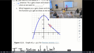 Still image of instructor's projected math equation with small inset of classroom view.